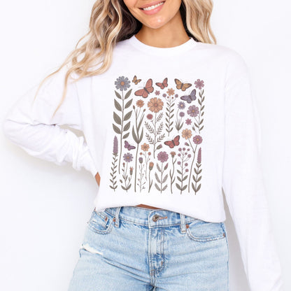 White long sleeve t-shirt with floral and butterfly design worn by a person, white background