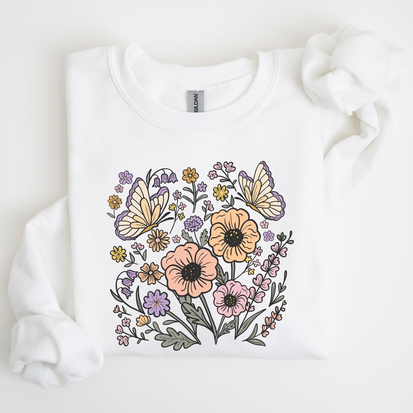White sweatshirt with floral and butterfly design on a light background