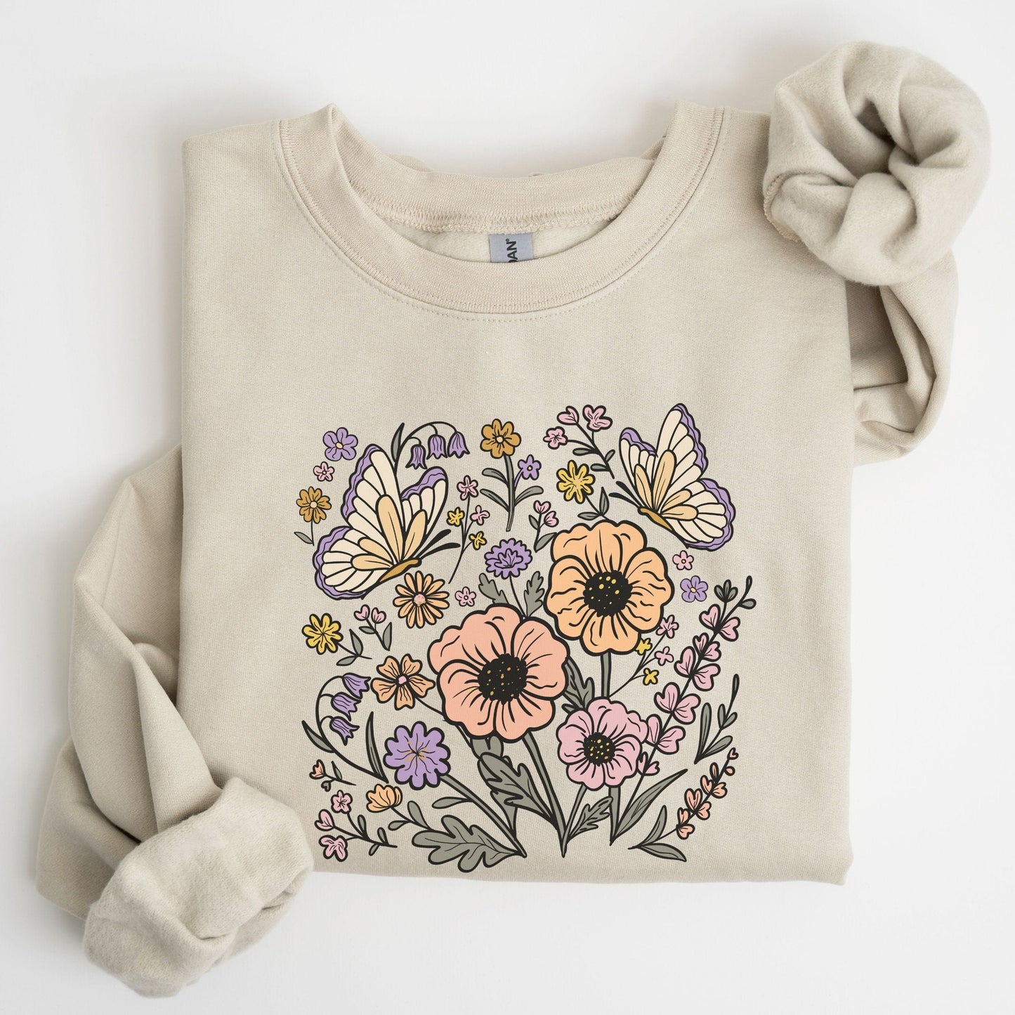 Beige sweatshirt with butterfly and floral design on a white background