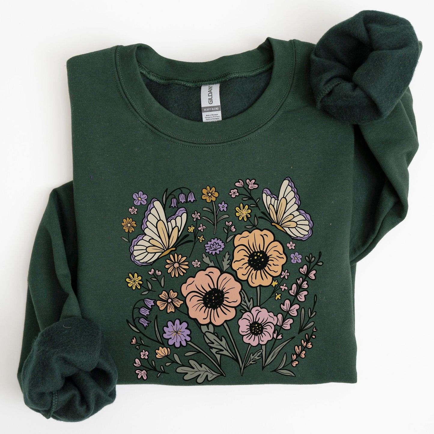 Green sweatshirt with floral and butterfly design on a white background