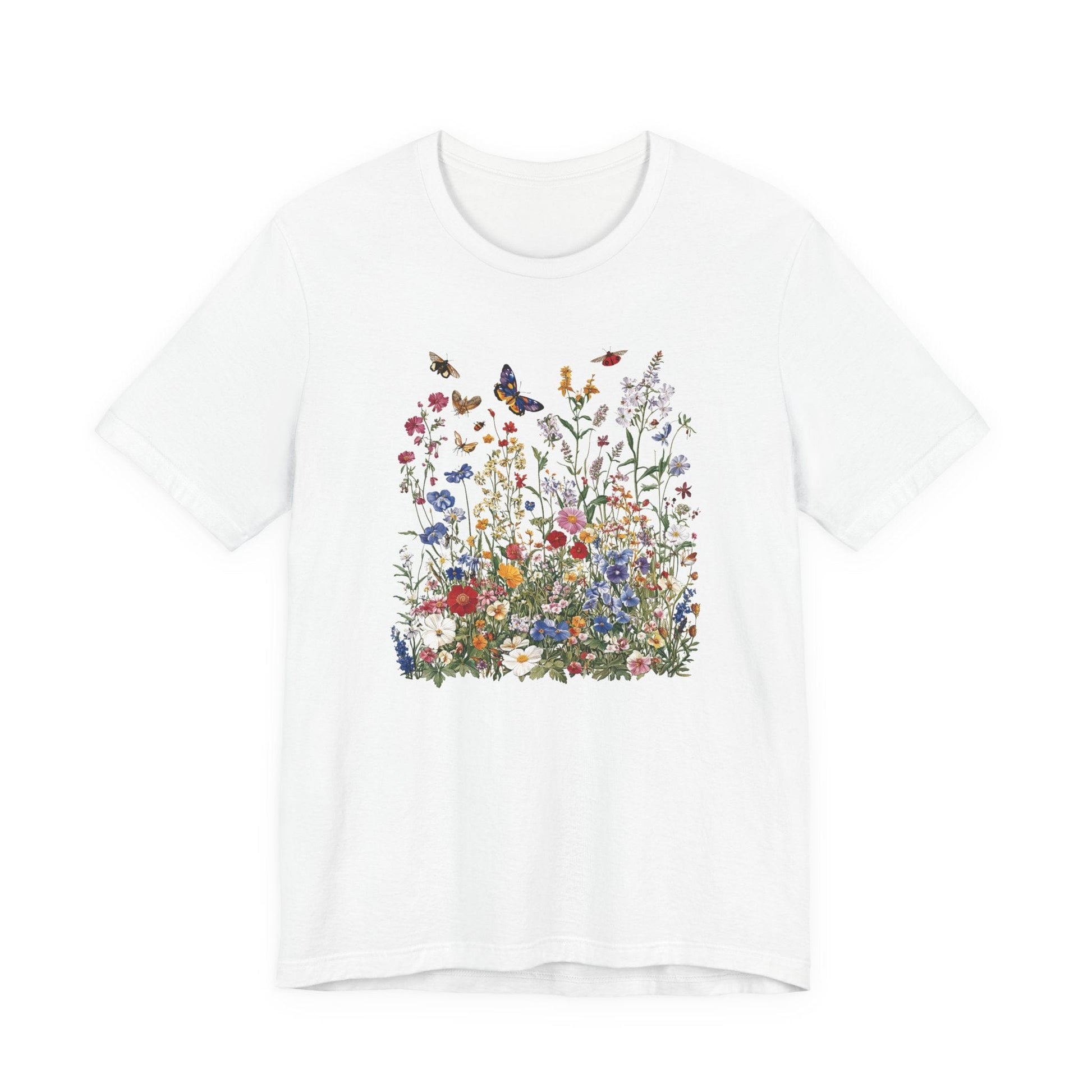 Flat lay of white t-shirt featuring colorful wildflower meadow with butterflies