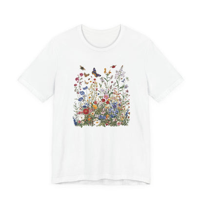 Flat lay of white t-shirt featuring colorful wildflower meadow with butterflies