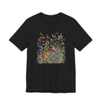 Flat lay of black t-shirt featuring colorful wildflower meadow with butterflies